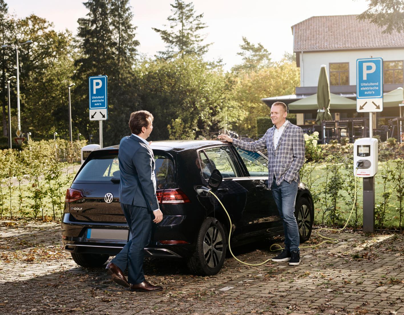 2 men with Ev charging point